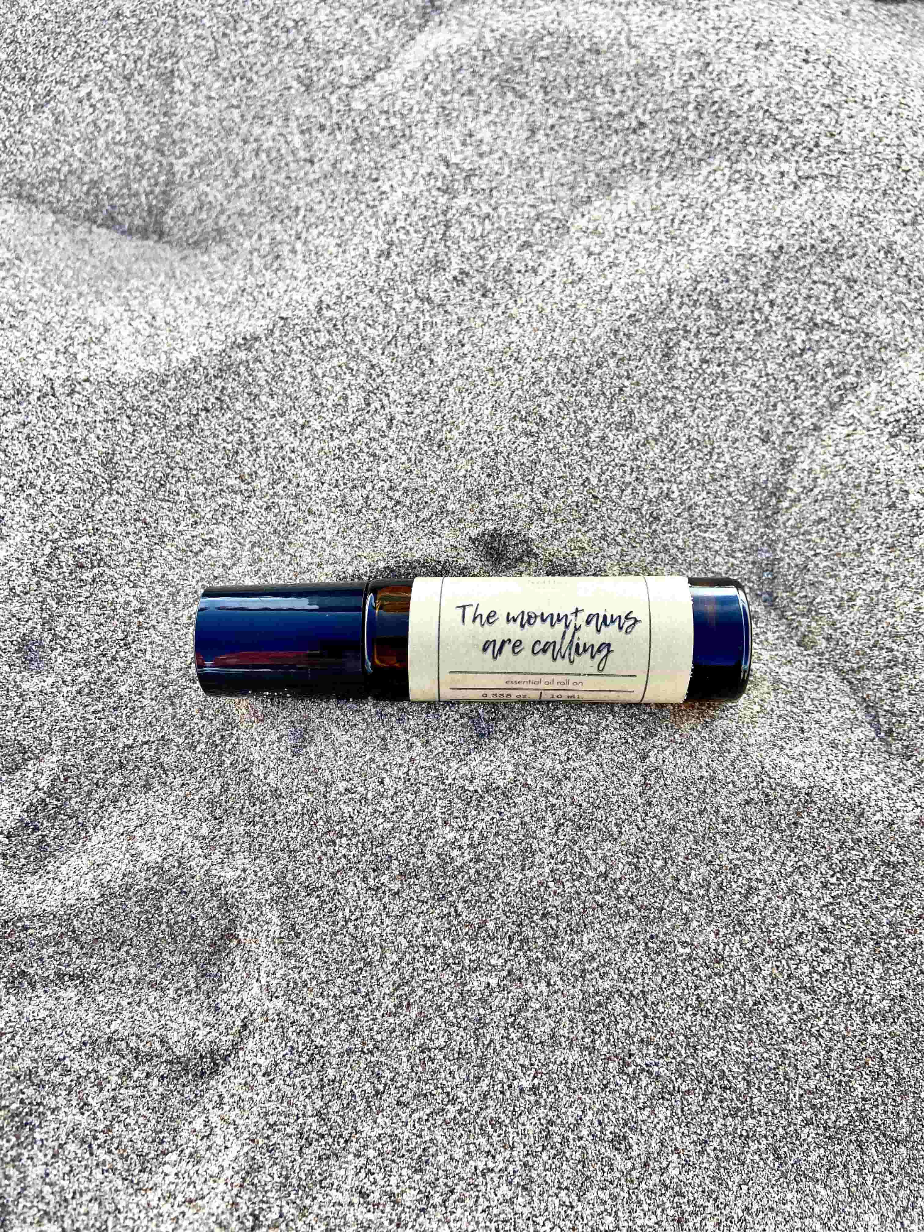 The Mountains are Calling Essential Oil Roll On. Made with 100% therapeutic grade essential oils and apricot oil, this natural and nourishing roll on has a woodsy, earthy aroma perfect for soothing stress and anxiety.
